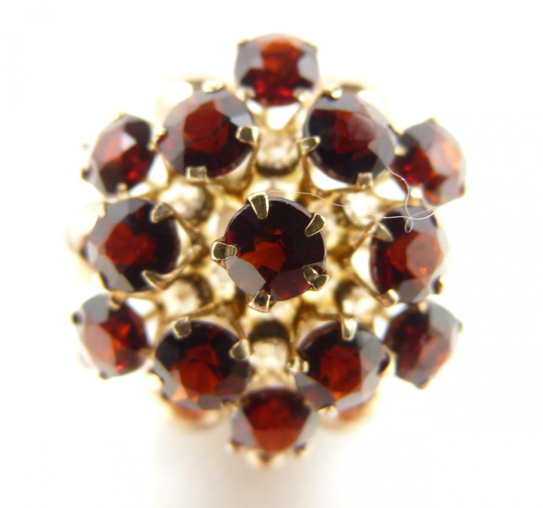 18KT YELLOW GOLD DOME GARNET RING: Dome style 18kt yellow gold garnet ring. Contains 13 garnets for a total of approximately 3.0cts. Set in a lovely 18kt flower mounting. Dome measures approximately 2.5cm X 2.5cm. Ring size 6 1/2. Tota