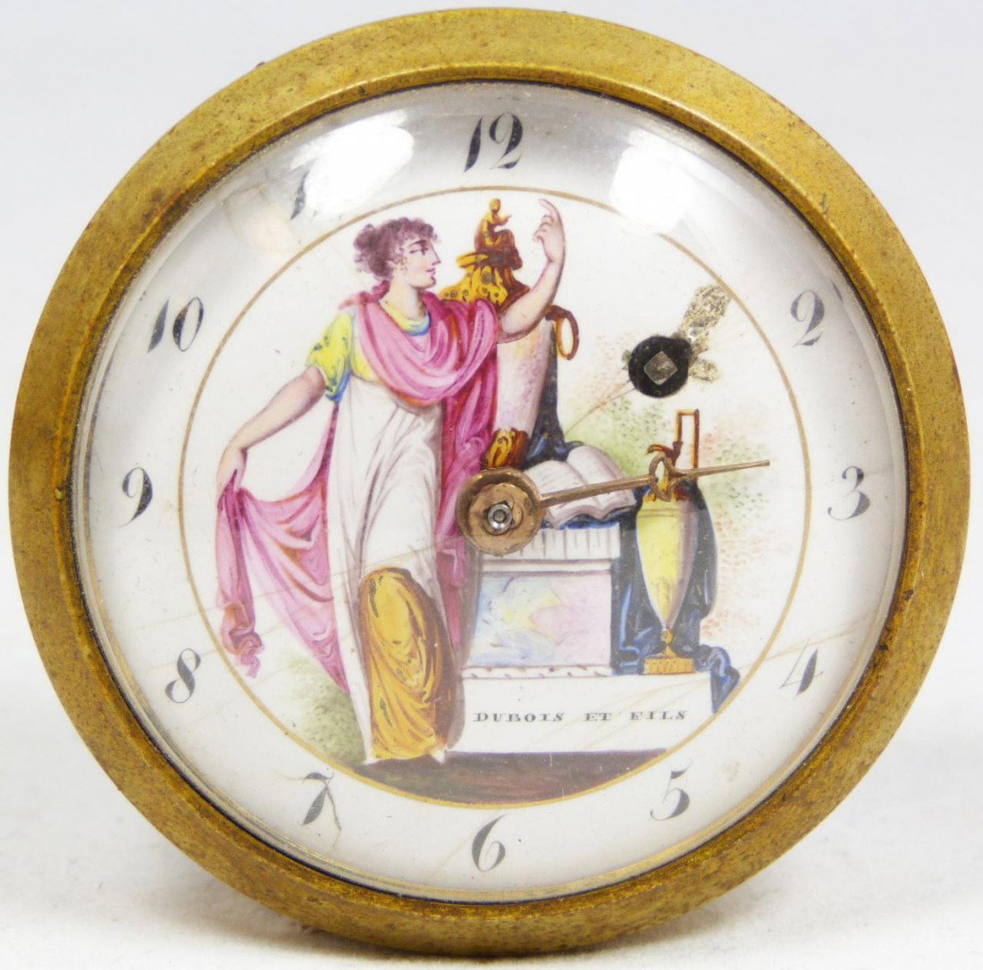 ANTIQUE DUBOIS ET FILS LEATHER CASE CLOCK: Beautiful antique Dubois Et Fils French desk clock. Has a fitted leather presentation case. Hand painted white enamel face depicting a woman with book and vase. 19th century. Measures 2" diameter (5cm
