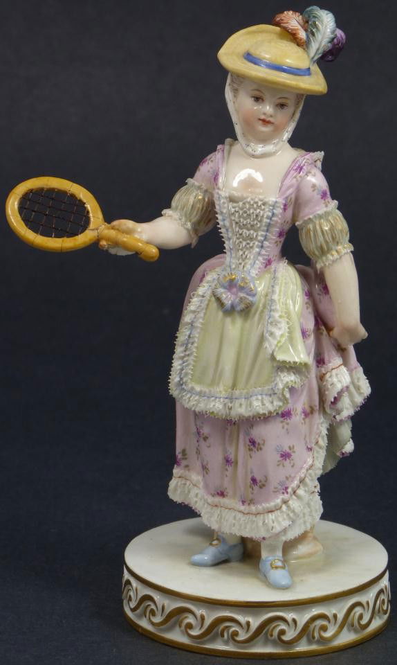 MEISSEN FIGURE OF GIRL w/ BADMITTEN RACKET: Antique Meissen German porcelain figure. Depicts a cherub with floral garland crown and grape clusters in hand. Blue crossed swords mark to bottom. Marked 58. in red. Etched F:1. 9. 19th century. Meas