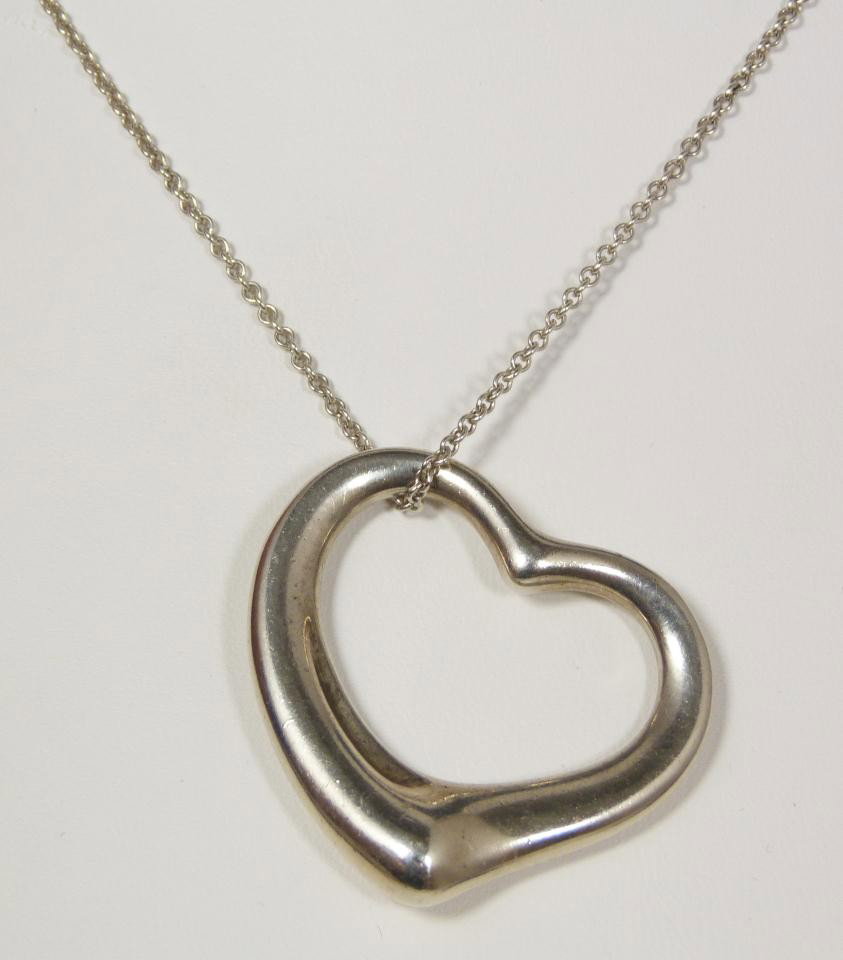 TIFFANY & CO. - PERETTI STERLING HEART NECKLACE: Sterling silver Perretti heart necklace made for Tiffany & Company. Elegant chain link necklace with stylized heart pendant. Chain and pendant signed Peretti and Tiffany & Co. Also marked Spain. Neckl