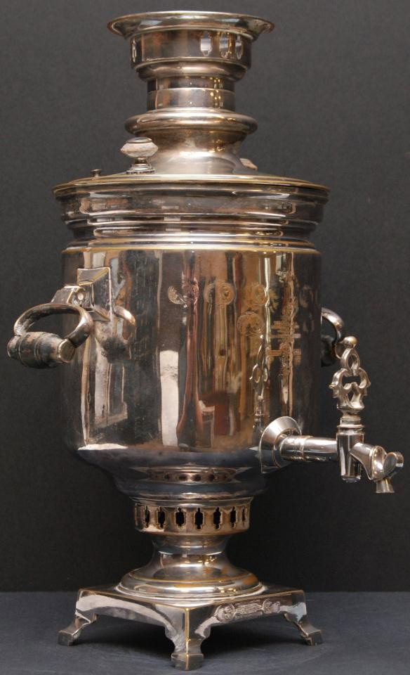 19th CENTURY RUSSIAN SILVERPLATE SAMOVAR: Antique 19th century silver on copper Russian samovar. Has monogram and dedication to front of body and foot in Cyrillic with medals. Dated 1899 to monogram on front. Has two hinged handles with carve