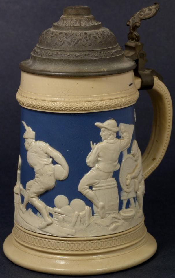 VILLEROY & BOCH METTLACH PORCELAIN LIDDED STEIN: Mettlach German porcelain half liter lidded beer stein made by the Villeroy & Boch Company. The stein depicts a pub scene with people drinking, smoking pipes, and playing bowling over blue background.