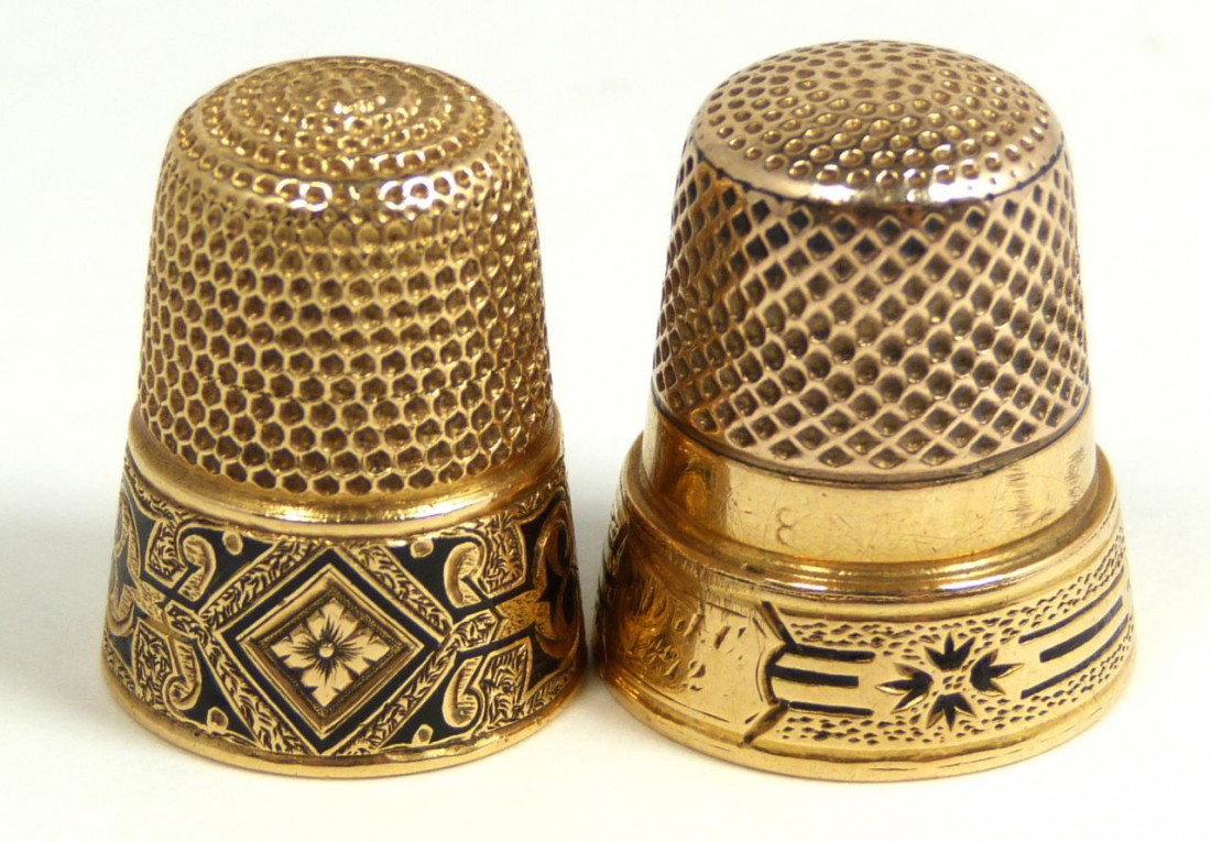 PAIR OF 22KT Y.G. THIMBLES: One has etched and black enamel floral border with a monogram of "Louise". The next has an etched floral black enamel border design and has a monogram of "MIJC 1872". Each measures approximately 1 1/8