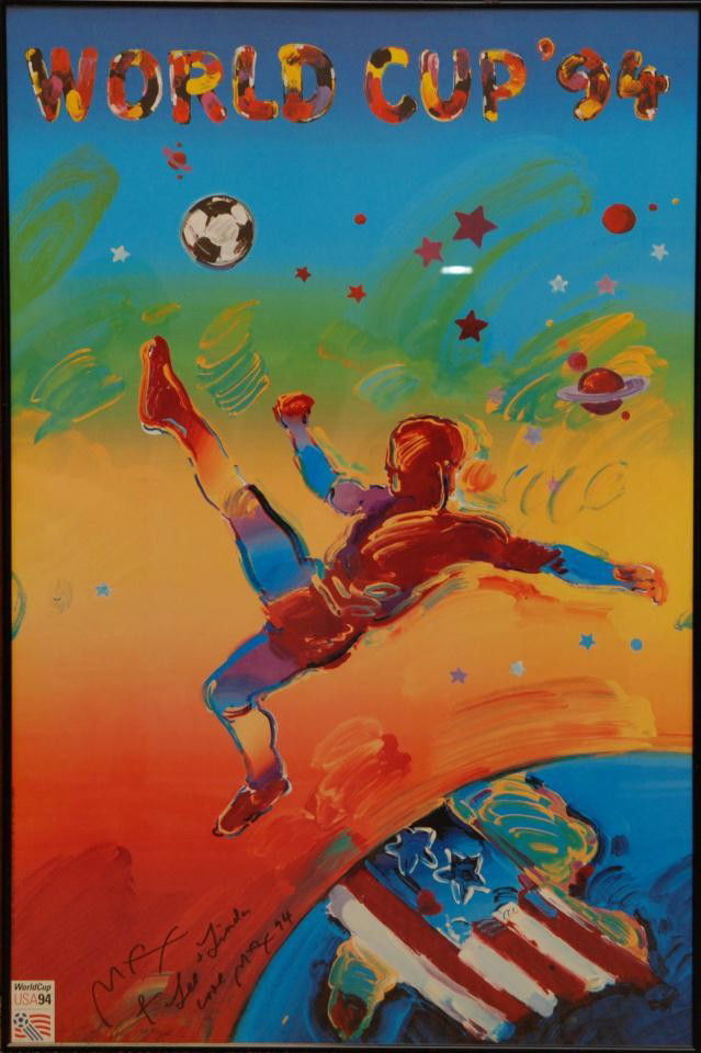 PETER MAX HAND SIGNED 'WORLD CUP '94' FIFA POSTER: Peter Max (AMERICAN/GERMAN, 1937) FIFA World cup 1994 signed poster. Signed lower left. Depicts a man performing a bicycle kick over the globe with the united states shown with flag. Measures 36" heig