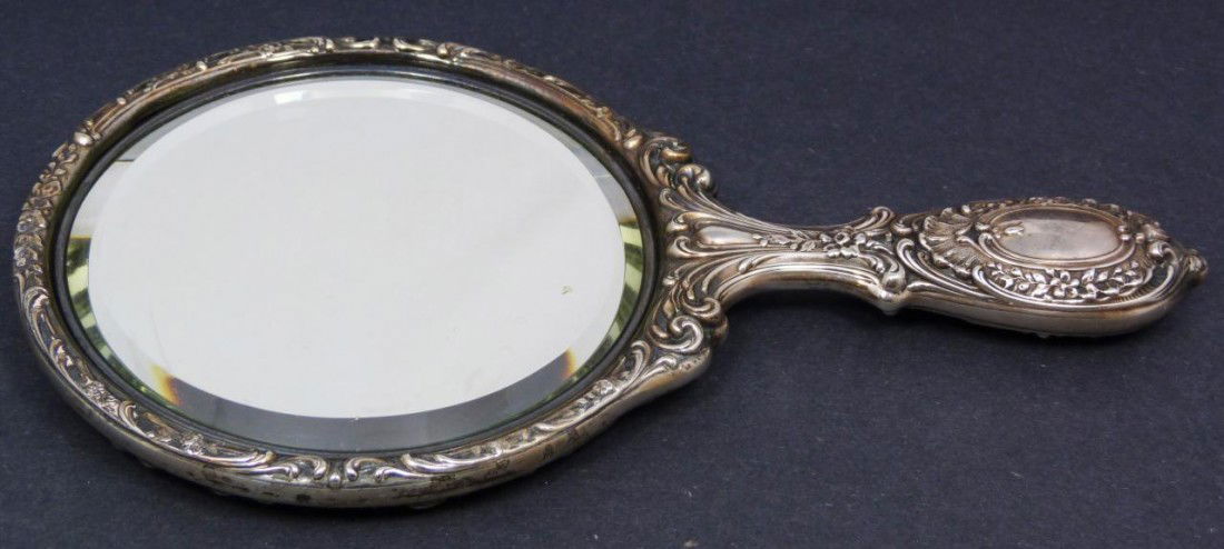 ANTIQUE GORHAM STERLING SILVER VANITY HAND MIRROR: Antique 19th century Gorham sterling silver vanity hand mirror with a beautiful scrolled floral repousse design. Holds old Gorham Lion / Anchor / G mark. Marked G465. Has delta mark denoting this mirr