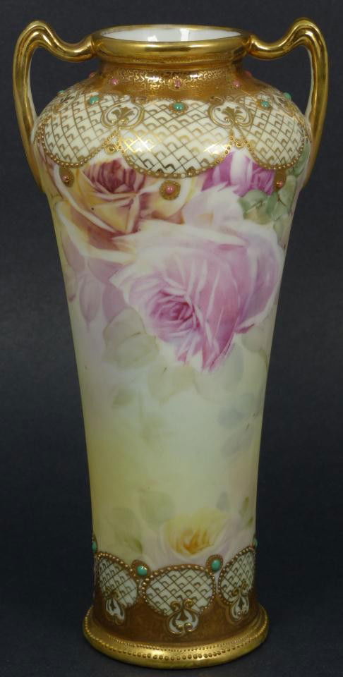HAND PAINTED NIPPON PORCELAIN FLORAL VASE: Lovely hand painted Nippon Japanese porcelain vase. Adapted amphora shape with two handles. Gilded lattice border designs with turquoise and red beading. Beautiful hand painted rose design among the q