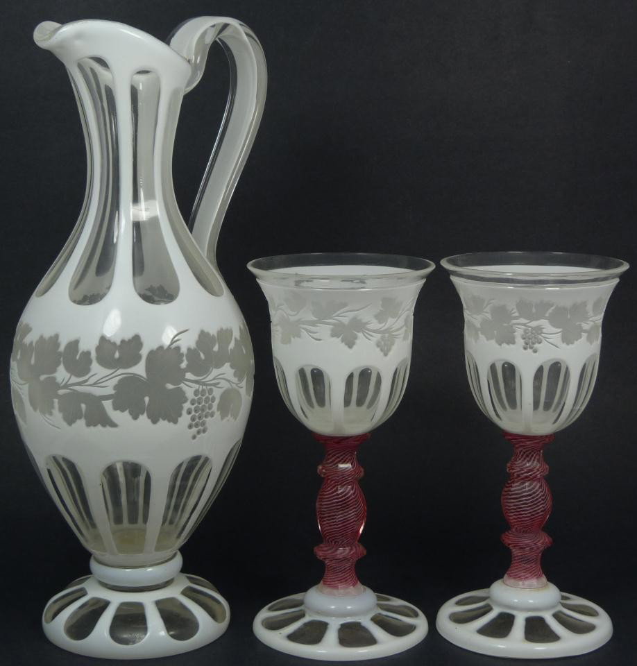 3pcs CUT TO CLEAR BOHEMIAN PITCHER & GOBLETS: 3 pieces of cut to clear Bohemian pitcher with goblets. Beautiful milk glass to clear glass design with cut grapevine with leaves and clusters to body. Goblets have a cranberry spiral design. Pitcher 