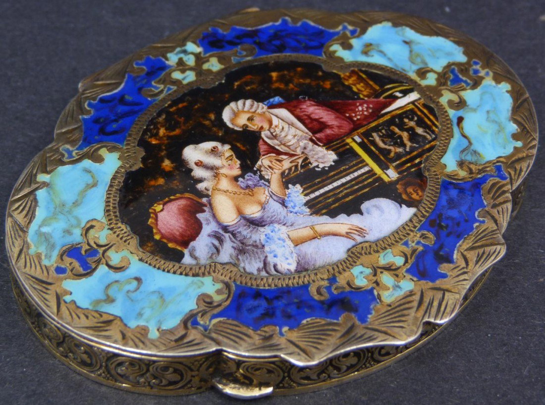 RISTORI RENATO ITALIAN 800 SILVER ENAMELED COMPACT: Antique Italian 800 silver & enamel compact. Has enameled design depicting a courting couple with Grand piano bordered by blue enamel. Silver has hand chased floral scrolled design throughout. Has mir