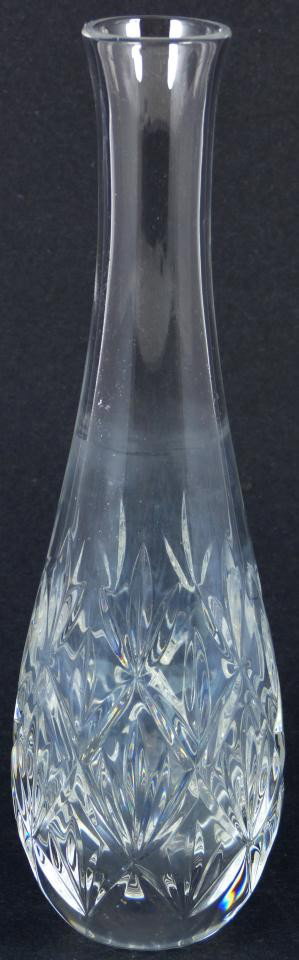 TIFFANY & COMPANY CUT CRYSTAL VASE: Tiffany & Company cut crystal vase. Has a cut line pattern design to bud body with elongated neck. Tiffany & Company mark to bottom. Measures 8 1/8" height (20.6cm).