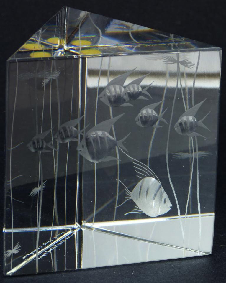 KOSTA BODA SWEDISH CUT CRYSTAL FISH PAPERWEIGHT: Kosta Boda crystal glass fish paperweight. Has a cut frosted design depicting fish and sea weeds. Has triangular shape. Signed Kosta Boda 97105 Lindstrand to bottom. Measures 4" height x 4" length x 4
