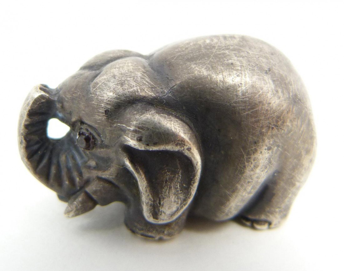 RUSSIAN SILVER ELEPHANT FIGURE WITH CABOCHON EYES: Russian silver elephant figure. Cabochon cut rubies set as eyes. Has town marks and 84 silver purity marks to bottom. Also holds Julius Rappaport Cyrillic workmaster mark to bottom. Measures 7/8" heig