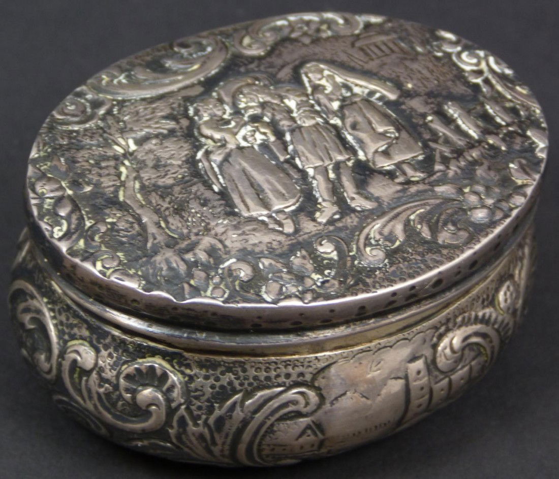 ANTIQUE ANDRE LOUIS FRENCH SILVER REPOUSSE BOX: Antique Andre-Louis French silver hinged box. Has a repousse design throughout depicting a man swooning two maidens to cover with intricate background and scrolled border. Side of body has a scroll de
