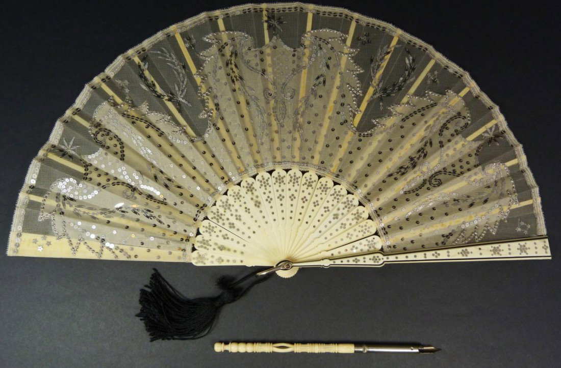 HAND CARVED OX BONE FAN AND PEN: Hand carved ox bone folding fan and pen. Fan measures 8 1/2" height. Pen measures 6 7/8" length (17.4cm).