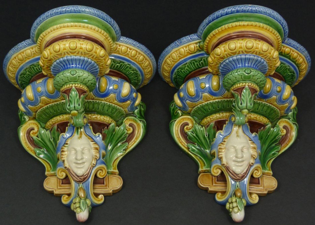Pr OF MINTON ENGLISH MAJOLICA WALL SHELVES: Pair of Minton English porcelain Majolica wall shelves. Each has a figural design depicting a a face with scrolled leaves and fruit. Each impressed Minton to back. Mid to late 19th century. Each measu