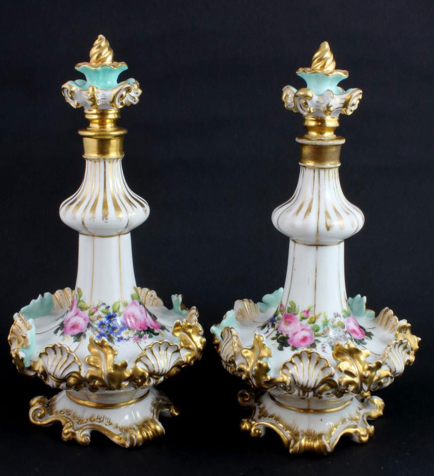 Pr 19th CENTURY JACOB PETIT FLORAL DECANTERS: Pair of beautiful floral Antique Jacob Petit French porcelain decanters with stoppers. Figural shell and leaf design to body with hand painted bouquet to neck. Each piece has blue JP mark to bottom. 1
