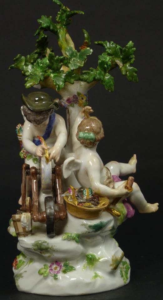 MEISSEN GERMAN PORCELAIN MALABAR GROUP FIGURE: Beautiful antique Meissen German porcelain group figure depicting two cherubs sharpening arrows. 19th century. Incised E22 and red 33C. Blue crossed swords mark to bottom. Measures 8 1/4" height (20.9