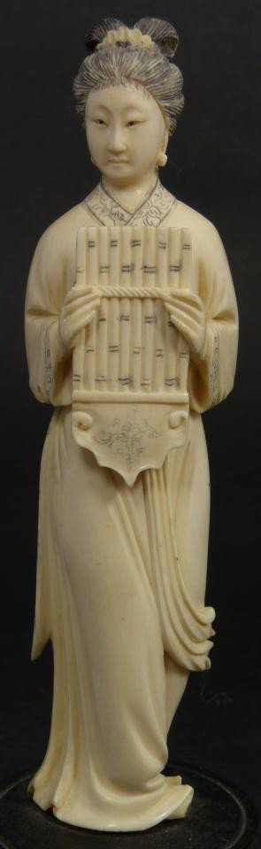 CHINESE HAND CARVED MINSTREL FIGURE w SHENG: Chinese carved ivory figure depicting a maiden with sheng woodwind instrument. She is depicted in layered robe and set on wooden reticulated base. 19th century. Measures 6" height + 1" base height (15
