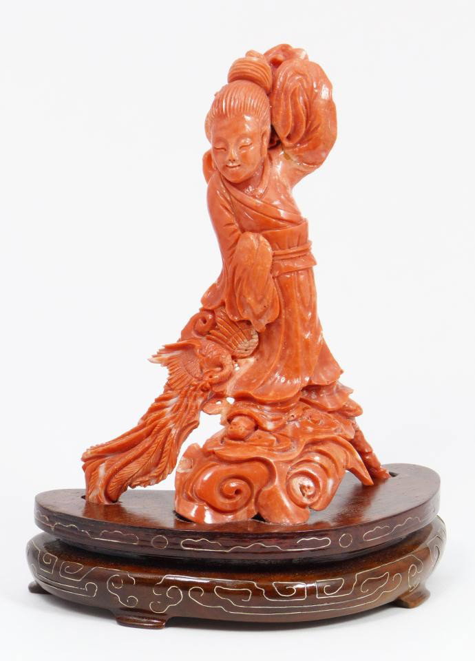 CHINESE HAND CARVED CORAL GUAN YIN FIGURE: Magnificent Chinese hand carved red coral Guan yin figure. She is depicted standing on clouds with Phoenix at side. Fine detail throughout down to the feathers on Phoenix. Includes fitted wooden silve