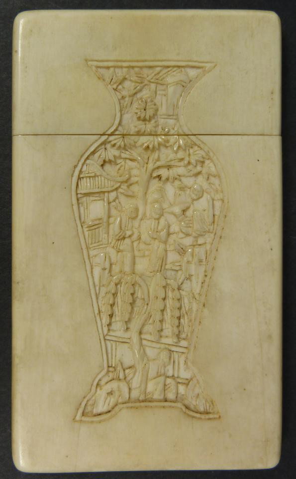 19th CENTURY CANTONESE CARVED IVORY CARD CASE: Antique hand carved Cantonese hand carved card case. Has relief carved design depicting groups of people with trees. Reverse depicts a vase with relief carved palace scene with people and trees. 19th 