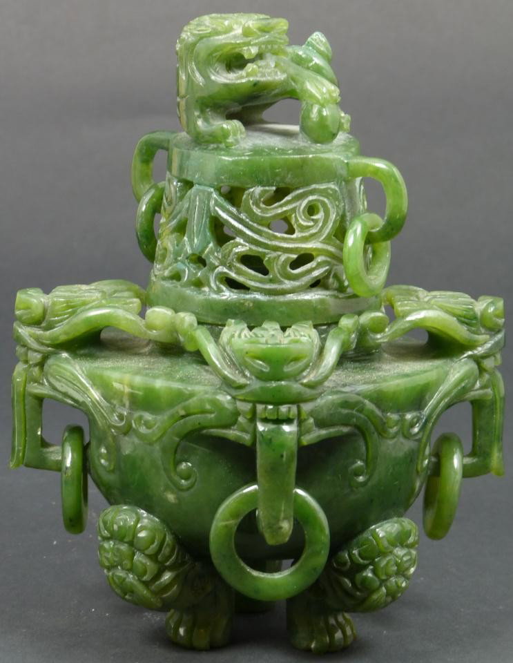 CHINESE HAND CARVED JADE DRAGONS CENSOR: Chinese hand carved jade sensor. Has a figural dragon design throughout with relief carved rings and beast feet. Fully reticulated screen cover with foo dog to top. Measures 5 1/2" height (13.9cm). To