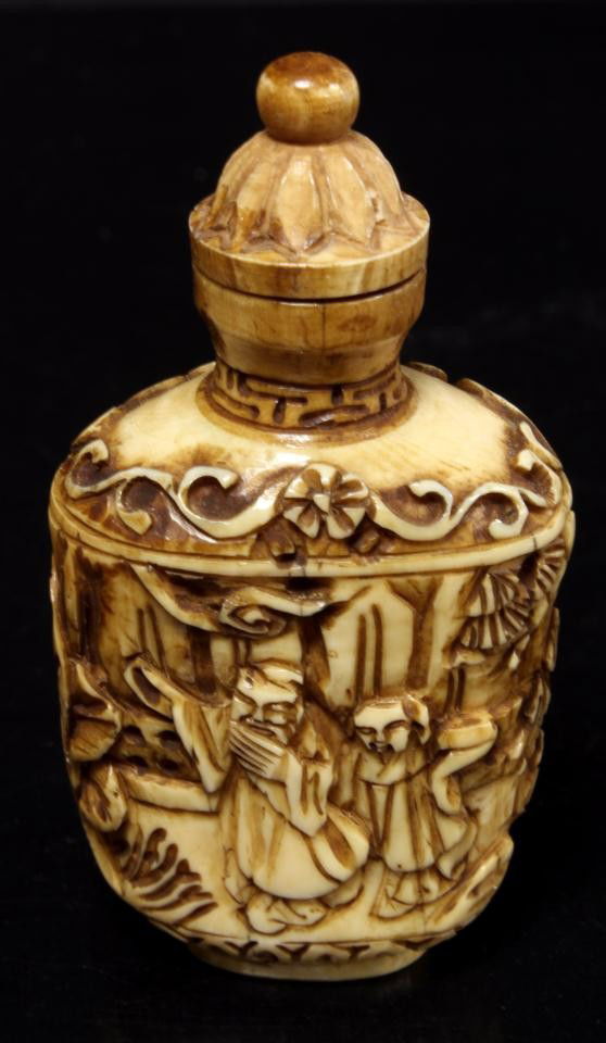 19th CENTURY HAND CARVED IVORY SNUFF BOTTLE: Antique hand carved ivory snuff bottle. Has relief carving throughout body depicting a wise man with attendant to one side and maidens with fan to other. 19th century. Measures 2 3/4" height x 1 1/2"