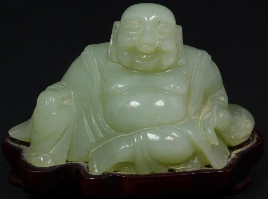 CHINESE HAND CARVED PALE GREEN JADE SITTING BUDDHA: Antique Chinese hand carved jade sitting Buddha figure. He is laughing with bag in left hand. Beautiful pale green translucence to jade. Includes fitted wodden base. 19th century. Measures 2 1/4" heig