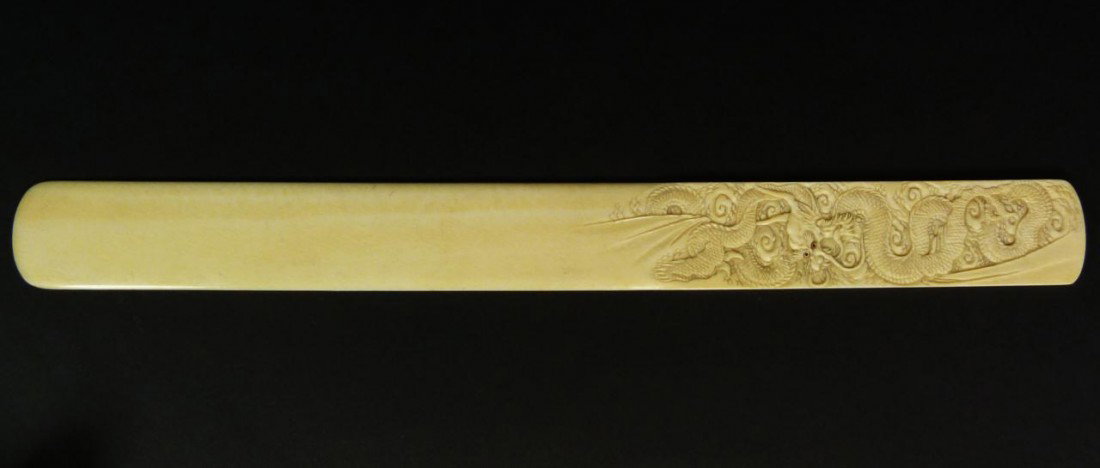 HAND CARVED IVORY DRAGON BOOKMARK SIGNED: Stunning hand carved ivory book mark having relief carved dragon design to handle on front and back. Finely carved. Signed to reverse. Measures 11 3/4" length x 1 1/4" width (29.8cm x 3.1cm). Total iv