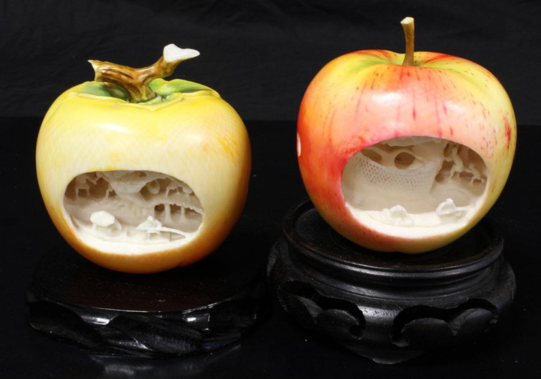 2 CHINESE IVORY RELIEF CARVED POLYCHROMED APPLES: 2 Chinese hand carved elephant ivory figural polychromed apples with relief carved village scene. Beautiful red and yellow coloring to exterior. Fine detail throughout. Scene depicts villagers doing v