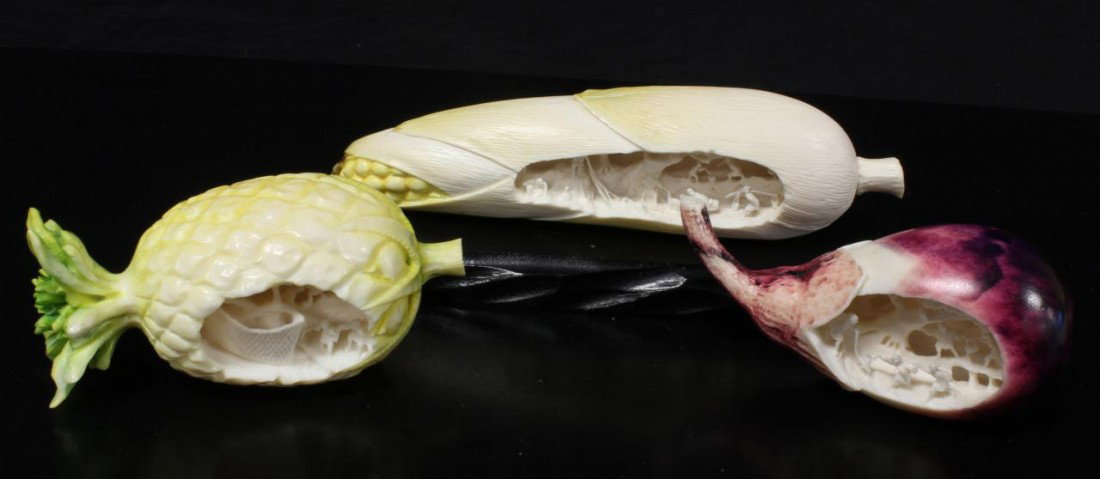 3 CHINESE IVORY CARVED POLYCHROME VEGETABLES: 3 Chinese hand carved elephant ivory figural polychromed vegetables and fruit with relief carved village scene. Lot includes a pineapple, eggplant and corn cob. Fine detail throughout. Scene depicts v