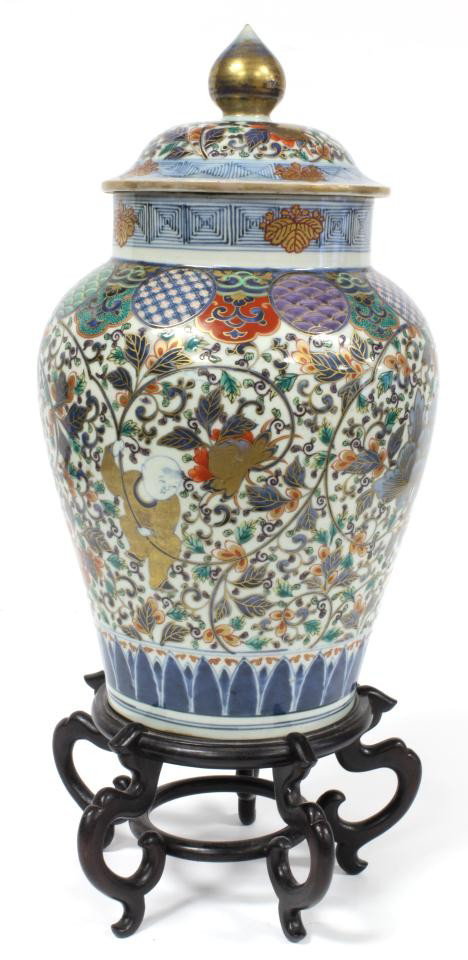 QING KANGXI CHINESE FLORAL BALUSTER VASE: Antique Chinese Qing Dynasty Kangxi hand painted and enameled covered baluster vase with intricate floral gilded design throughout. 18th/19th century. Includes fitted wooden display stand. Measures 15