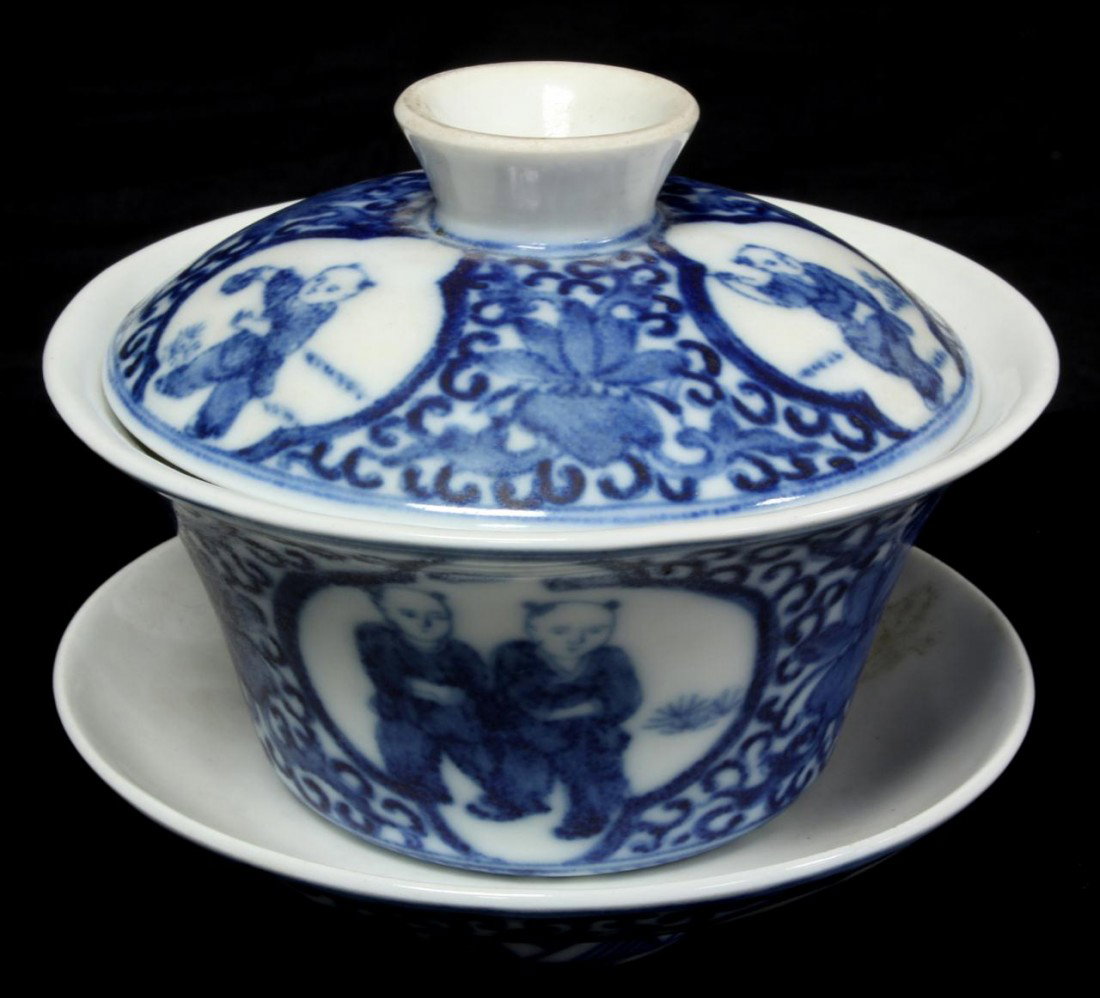 CHINESE QIANLONG BLUE & WHITE PORCELAIN COV'D CUP: 3 piece Chinese Qing Dynasty blue & white hand painted covered cup with saucer depicting young children. Holds Qianlong calligraphy reign marks to bottom. Measures 3 3/4" height x 4 1/2" diameter (9.5