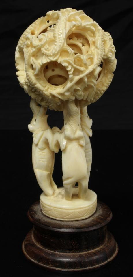 CHINESE HAND CARVED IVORY CONCENTRIC BALL w STAND: Chinese hand carved ivory dragon concentric ball having approximately 6 layers. Has figural three dancing elephants stand with trunks and tusks pointing up. Set on wooden base. Measures 4" height + 7/