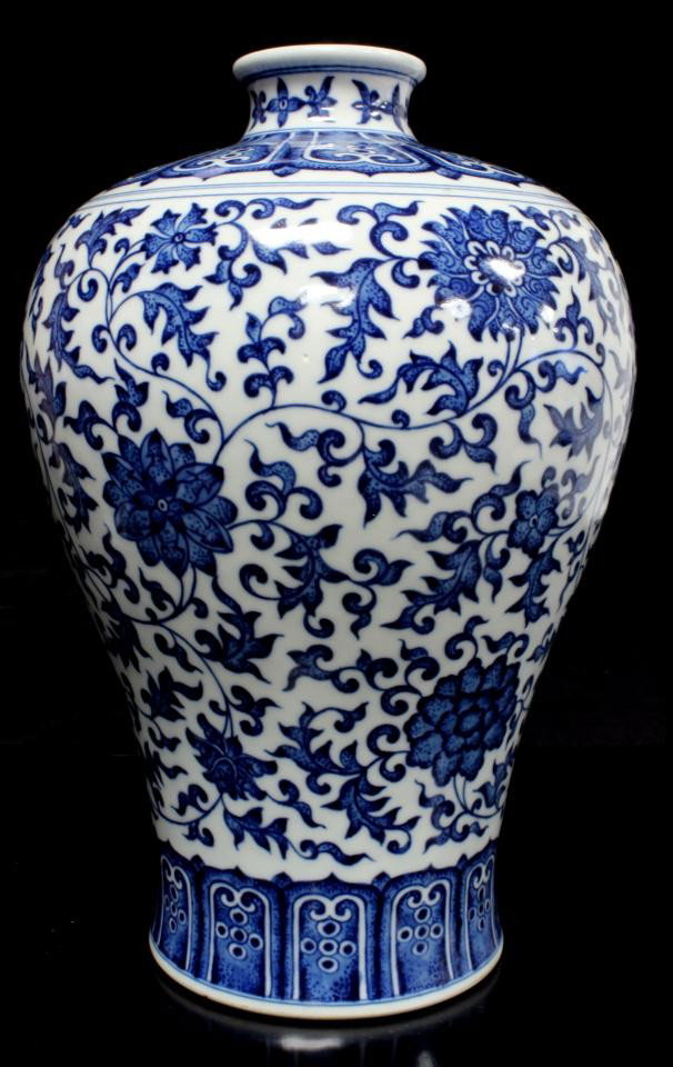 CHINESE QIANLONG BLUE & WHITE PORCELAIN VASE: Chinese Qing Dynasty blue & white hand painted Mei Ping vase. Beautiful scrolled floral design throughout with fan bordering. Holds Qianlong archaic reign marks to bottom. Measures 10 7/8" height x 8 