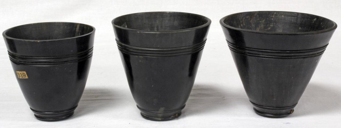 3 18th CENTURY CARVED RHINO HORN CUPS: Lot of 3 hand carved antique rhinocerous horn cups. Each having rounded conical shape with 4 horizontal line etched design to rim and 2 etched lines near foot. 18th century. Largest measures 4 3/8" he