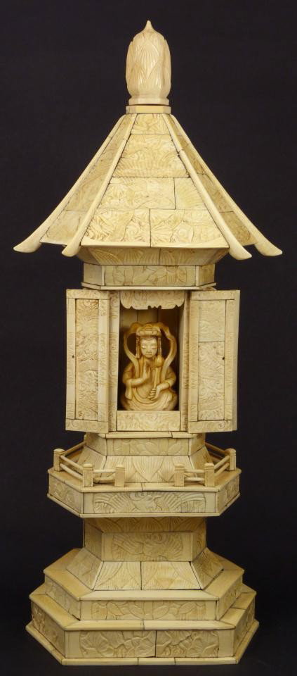 ANTIQUE CHINESE IVORY TEMPLE SHRINE WITH GODDESS: Antique Chinese hand carved ivory pagoda temple with relief carving throughout. Depicts sages with Phoenix and flowers. Very intricately carved and designed. Front of temple opens to depict seated god