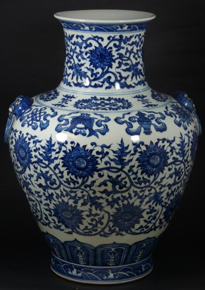 CHINESE BLUE & WHITE PORCELAIN QIANLONG VASE: Chinese Qing Dynasty blue & white hand painted Mei Ping vase. Beautiful scrolled floral design with calligraphy to center of flowers. Has fan, fish and vase bordering. Has two foo dog head with ring h