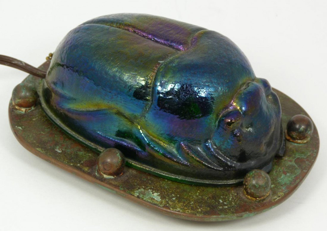 TIFFANY STUDIOS BRONZE & ART GLASS SCARAB LAMP: Tiffany Studios bronze and iridescent art glass scarab beetle desk lamp. Marked Tiffany Studios 450 to bottom. Circa 1900. Measures 2 1/2" height x 6" length x 4 1/2" depth (6.3cm x 15.2cm x 11.4cm).