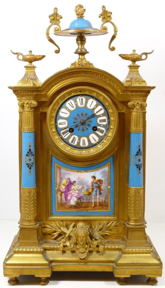 MANTEL CLOCK BRONZE PORCELAIN SEVRES STYLE: This porcelain and Dore bronze mantel clock epitomizes the Sevres style popular during the 19th century. A porcelain urn with bronze scroll and fleur de le juxtaposed with stylized Aladdin urn finials