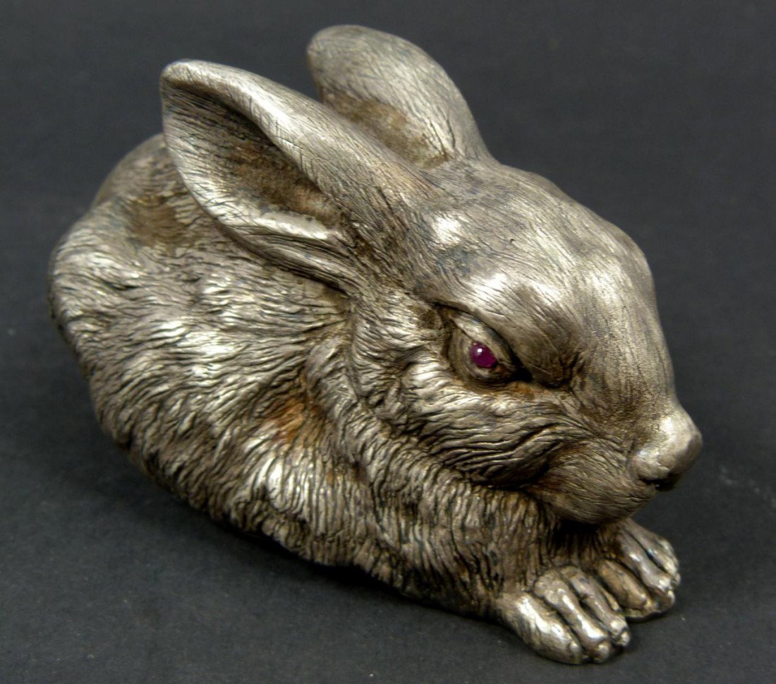 RUSSIAN SILVER RECUMBANT RABBIT FIGURE: Russian silver rabbit figure. Has cabochon cut garnet stones set to eyes. Has town marks and 84 silver purity marks to bottom. Also holds Julius Rappoport's "I.P." workmaster mark to bottom. Measures 
