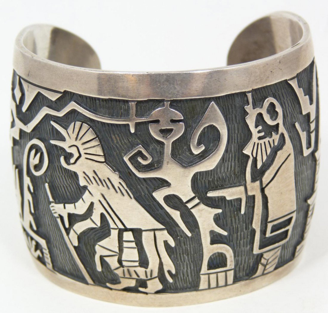 LARGE OLD TRADE STERLING ZUNI CUFF BRACELET: Very detailed old trade sterling silver Zuni cuff bracelet. Highly detailed with corn harvest and spirit scene. Large and signed "S.TOM". Circa 1940's. Rare piece. Total sterling weight (70.2dwt.)109.