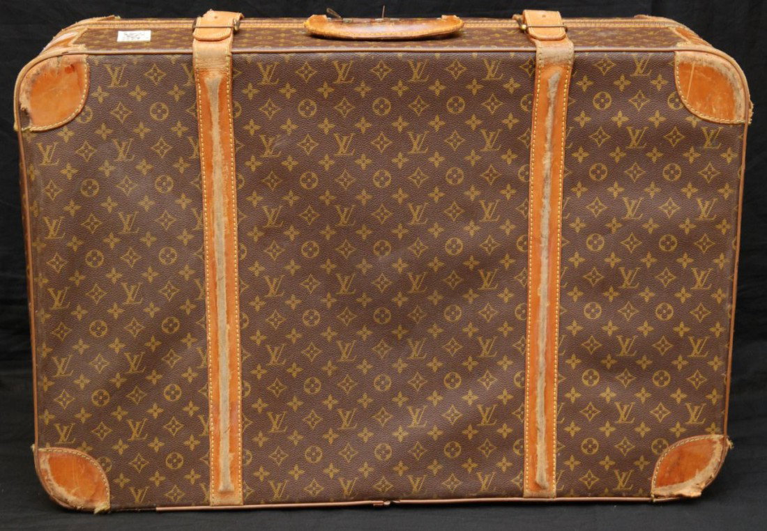 LOUIS VUITTON SOFTSIDE TRAVEL LUGGAGE: Louis Vuitton medium softside suitcase with two leather straps, Made in France 1925-1975. Measures 21" high x 31" wide x 10" deep (53.7 cm x 79.2 cm x 26 cm).