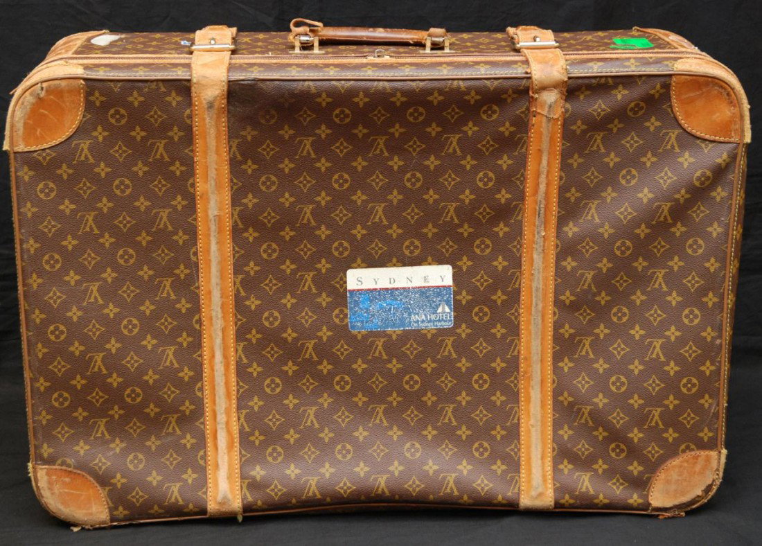 LOUIS VUITTON SOFTSIDE TRAVEL LUGGAGE: Louis Vuitton medium softside suitcase with two leather straps, Made in France 1925-1975. Measures 21" high x 31" wide x 10" deep (53.7 cm x 79.2 cm x 26 cm).