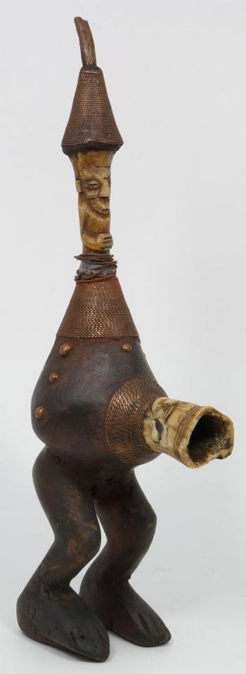 ANTIQUE AFRICAN HAND CARVED WOOD AND BONE PIPE: Antique African hand crafted figural pipe. Has wooden body with carved bone head extending from the stomach as the tobacco chamber. The stem is also a carved figural bone. 18th/19th century. Measures 