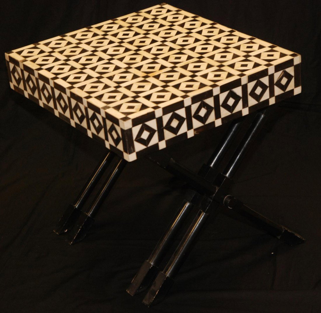 AFRICAN IVORY AND BONE INLAID TABLE: Handcrafted table/stand decorated in geometric pattern of African design. Repeating diamond motif of ivory and bone with hinged lid opening to reveal interior storage compartment and all resting on tu