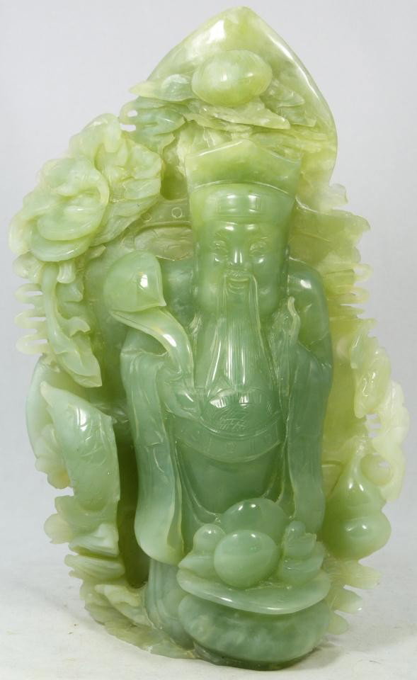 CHINESE HAND CARVED SERPENTINE JADE DEITY FIGURE: Hand carved Chinese apple green deity jade group figure depicting. There are fish, bats with coins, double gourds and flowers throughout the scene. Clouds and rock formations can also be seen. Reverse