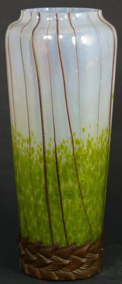 LOETZ ART GLASS OPALESCENT VASE WITH APPLIED LEAF: Loetz, Austria, 1895-1905. Opalescent, art glass vase, oblong, green iridescent surface, ribbed, applied foliage base in naturalistic design, indicative of Loetz during the Art Nouveau period of the 1