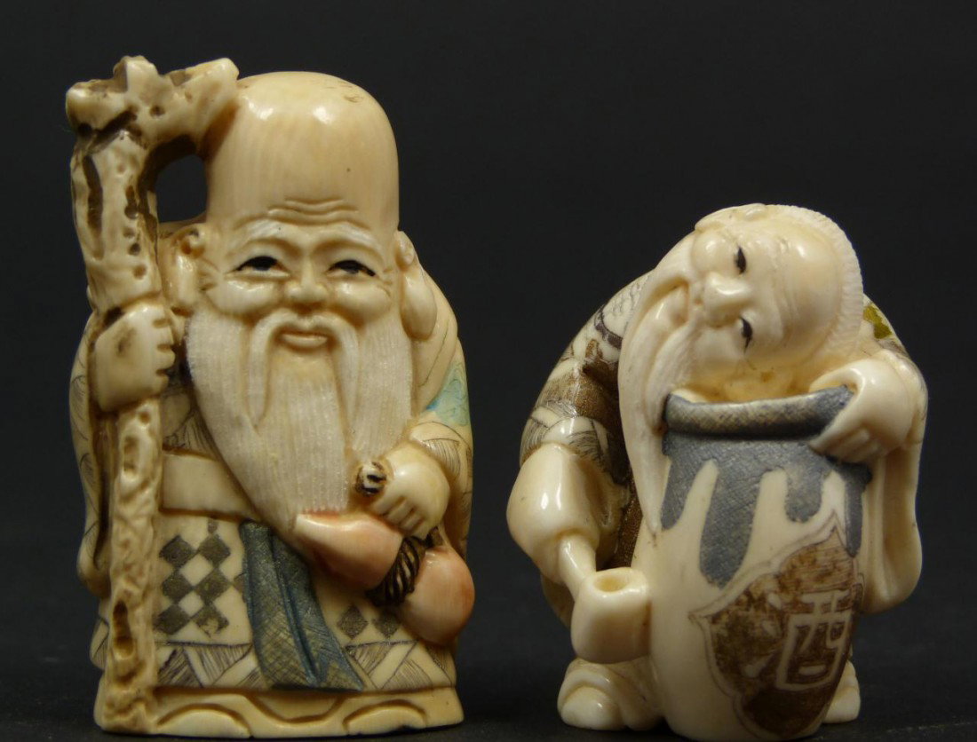 2 JAPANESE HAND CARVED IVORY NETSUKE FIGURES: 2 hand carved polychromed netsuke figure depicting Shou Xing and sage with water vase. Each figure singed to bottom. Largest measures 1 7/8" height x 1 1/8" width (4.7cm x 2.8cm). Total weight of 38 g