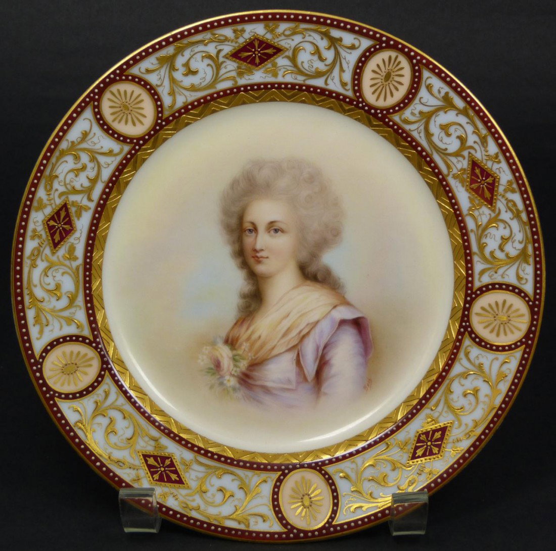 ROYAL VIENNA HAND PAINTED PORTRAIT PLATE SIGNED: Magnificent antique Royal Vienna hand painted porcelain portrait plate. Depicts portrait of woman with gray hair and flower to front of dress. Has stunning gilded scrolled floral border design over re