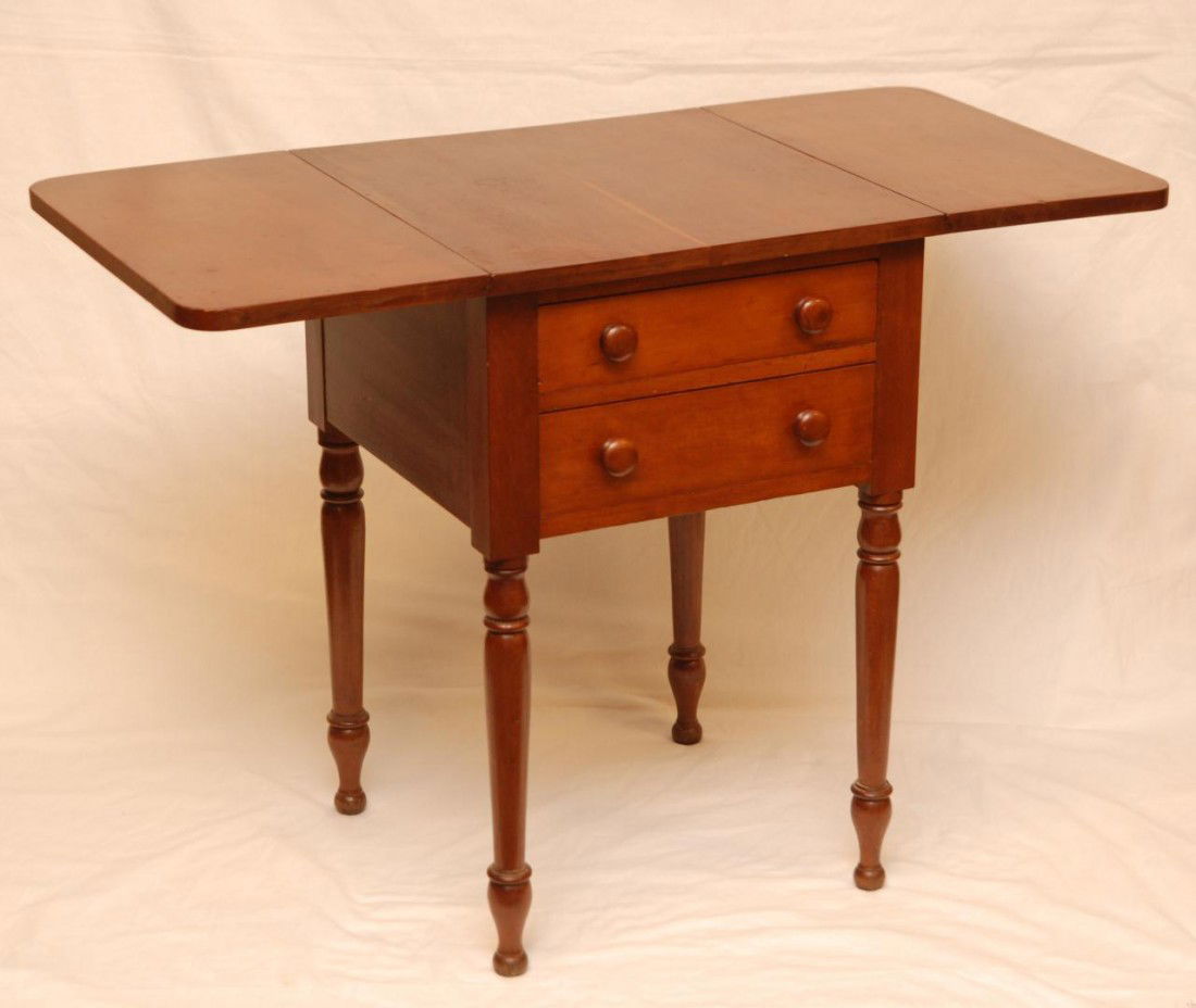 AMERICAN MAPLE PRIMATIVE PEMBROKE TABLE 1890: Antique, Pembroke table in maple with two lateral stacking drawers, mounted wood knobs, double drop leaves, all resting on turned spindle legs and dove tail construction. Measures: 28 ½" High x 18 ½