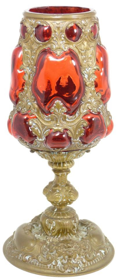 RENAISSANCE REVIVAL CHALICE BRONZE AND RUBY GLASS: Renaissance Revival, Continental, 1890-1930. Handsome chalice, sculpted in bronze naturalistic scrolls and masks, with blown, ruby glass accent. Circa 1850. Measures: 11 ½" height x 5 ½" diameter (2